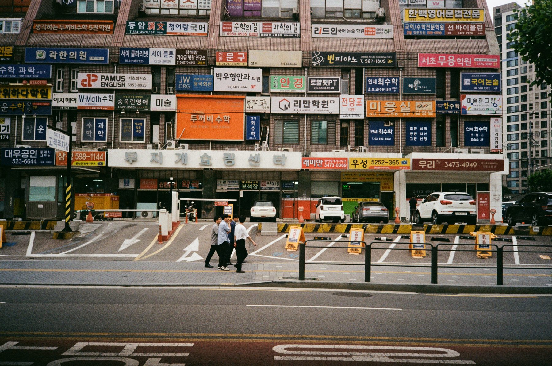 busy korean shopfront with cars, taken on 35mm film — analogue.aesth